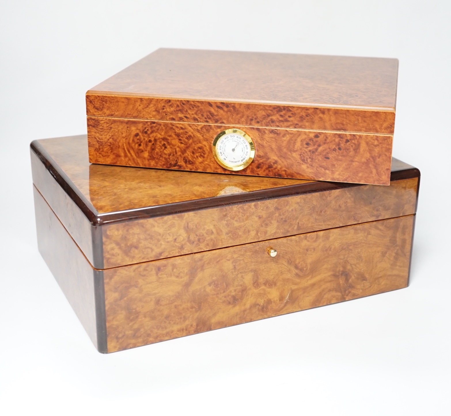 Two burr wood humidors, one with contents including Cohiba